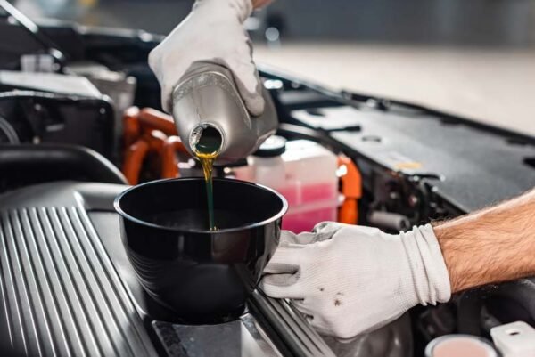 cropped-view-of-mechanic-pouring-oil-to-car-engine-2023-11-27-05-18-13-utc