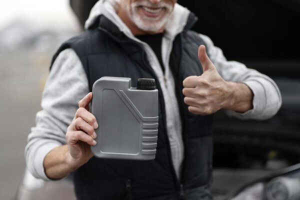 focus-on-the-container-with-engine-oil-in-the-hand-2023-11-27-05-17-15-utc